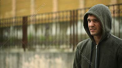 Frustrated by the weather, standing in the rain. The Unfortunate Man