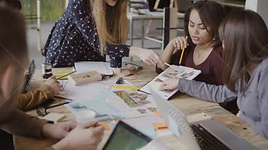 Young creative business team in modern office. Multiethnic group of people working on architectural design together.