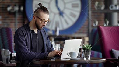 A serious writer prints on the keyboard of the laptop the text of the documentary novel that came to mind, a man with