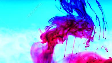 Ink in water. Colour ink reacting in water creating abstract cloud formations