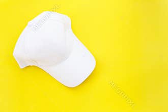 New blank white baseball hat on yellow background with free space for design