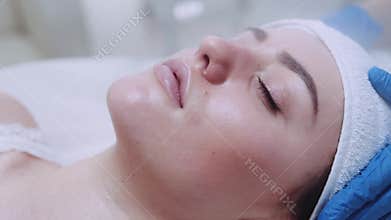 Extreme close up view of a beautiful femaleâ€™s face with closed eyes being cleaned with steam therapy in beauty spa