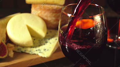 Glass of red wine on a background of cheese plate