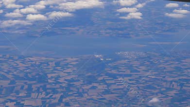 Plane flies highly over Earth and clouds