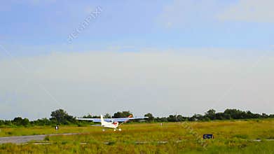 Small airplane are landing on runway.