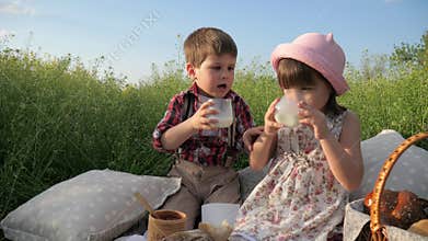 Healthy food for healthy child, Children at picnic, family is resting in nature, kid drinking milk, happy girl eating