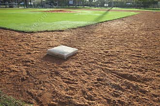 Baseball field infield with first base in the foreground