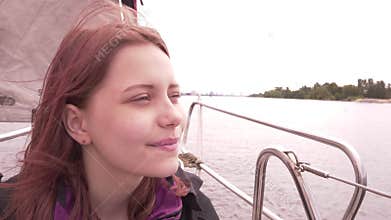 Young girl on a boat enjoys fresh sea air 4K UHD slowmo