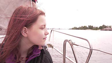 Young girl on a boat enjoys fresh sea air 4K UHD slowmo