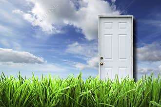 White door isolated in spring landscape