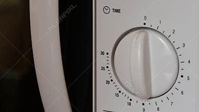 Using a microwave to cook food.