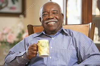 Senior man drinking hot beverage