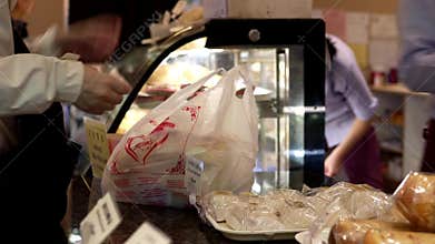 Motion of people buying bread and paying cash