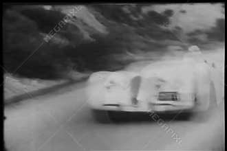 Two sports cars attempting to overtake each other during race