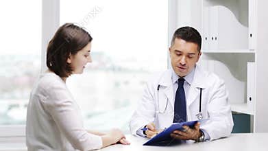 Smiling doctor and young woman meeting at hospital