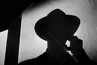 Silhouette of man speaking on telephone