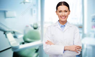 Happy young female dentist with tools