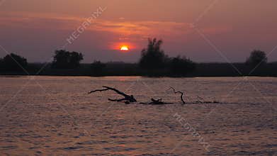 Beautiful sunset landscape - Danube Delta, landmark attraction in Romania. Danube River