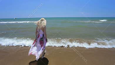 Woman in dress trying warm water.