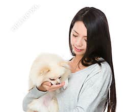 Woman feed her pomeranian dog
