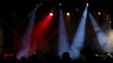 Rock concert stage with colored spotlights and smoke