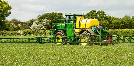 John Deere sprayer spraying in bean field