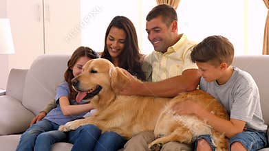 Happy family smiling with their dog