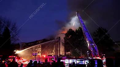 Firefighter crews battling apartment complex fire at night