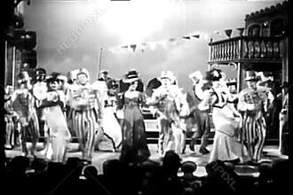 Actors in costumes dancing and singing on stage