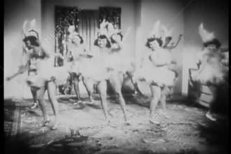 Women in costume practing dance routine in living room