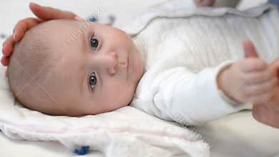 Baby gripping mother's finger