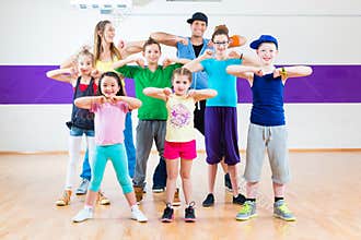 Dance teacher giving kids Zumba fitness class
