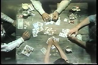 High angle view of people playing cards on wooden table