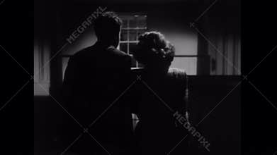 Rear view of couple walking in house