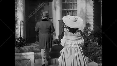 Rear view of couple entering house