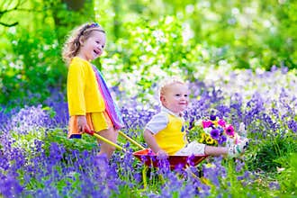 Kids in a garden with bluebell flowers