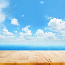 Wood table top on blue sea water and bright summer sky background
