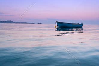 Lonely traditional greek fishing boat on sea water