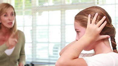 Upset mother scolding her daughter