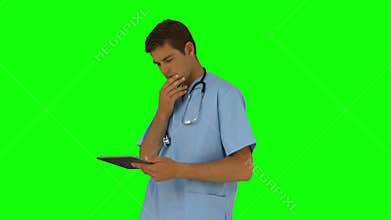 Surgeon standing using his tablet pc