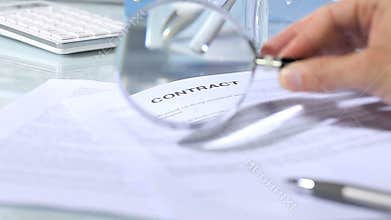 Looking through a magnifying glass to contract