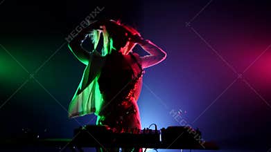 Young sexy, blonde woman dj, bending, in white