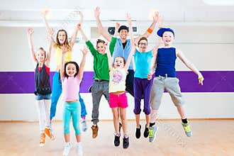 Dance teacher giving kids Zumba fitness class