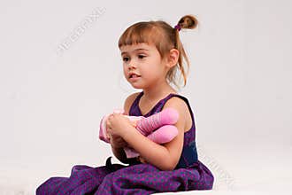 Little girl holding doll