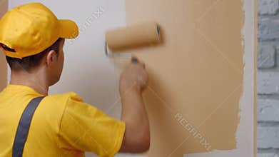 Builder paints white wall.