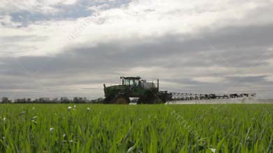 The sprayer sprays young wheat