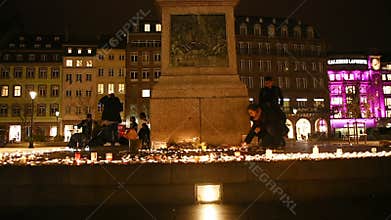 People attend a vigil and light candles