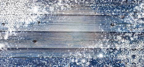 Blue winter wooden background with snowflakes around. Christmas, New Year card with copy space in the center