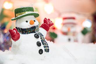 Snowman stand among pile of snow at silent night with a light bulb,Merry christmas and new year night.