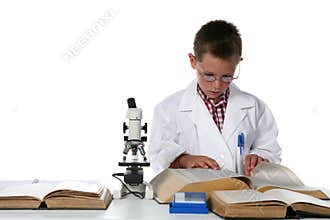 Young boy in lab coat taking notes
